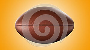 American football ball rotating in motion on orange screen. Looped American football 3d Animation. 3d. 4K