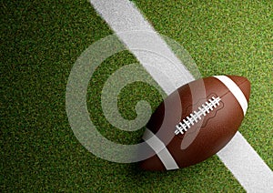 American football ball on stadium grass at night. Copy space