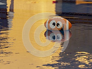 American football baloon in a pool photo