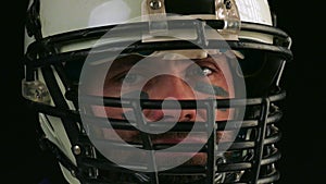 American football. Close-up of american football player in helmet looking into camera. Confident look of an American