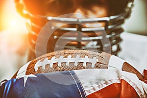 American football concept. The ball for the American football lies on the flag of America against the background of the