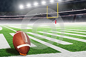 American football field goal post with ball on kicking tee