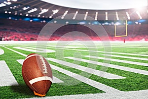 American football field goal post with ball on kicking tee