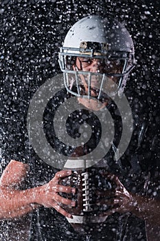 American Football Field: Lonely Athlete Warrior Standing on a Field Holds his Helmet and Ready to Play. Player Preparing