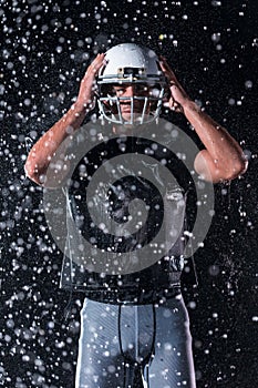 American Football Field: Lonely Athlete Warrior Standing on a Field Holds his Helmet and Ready to Play. Player Preparing