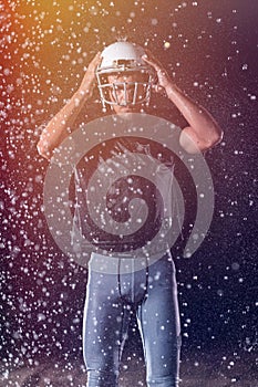 American Football Field: Lonely Athlete Warrior Standing on a Field Holds his Helmet and Ready to Play. Player Preparing