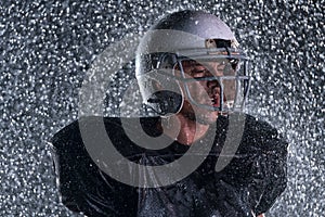 American Football Field: Lonely Athlete Warrior Standing on a Field Holds his Helmet and Ready to Play. Player Preparing