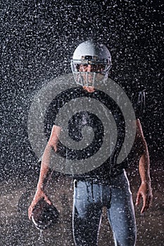 American Football Field: Lonely Athlete Warrior Standing on a Field Holds his Helmet and Ready to Play. Player Preparing