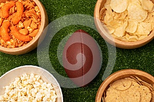 American football flat lay photography with snacks and american football ball