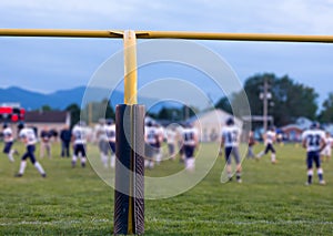 American football goal posts with blurred team