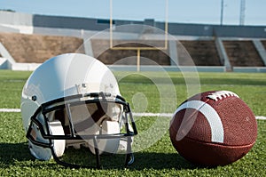 American Football and Helmet on Field photo