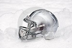 American football helmet in snow