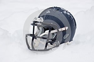 American football helmet in snow