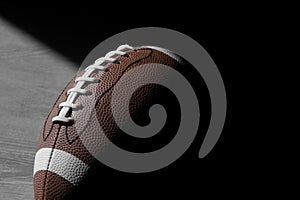 American football leather ball on grey wooden background