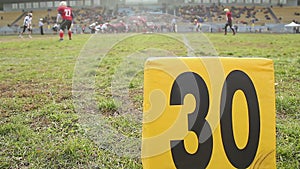 American football match, players ready for ball snap scrimmage, 30-yard line