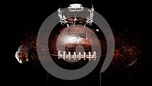 American football player, athlete in helmet with ball on black background. Sport wallpaper with copyspace.