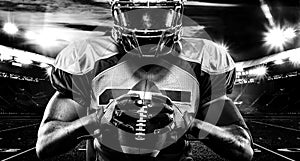 American football player, athlete in helmet with ball on stadium. Black and white photo. Sport wallpaper with copyspace.