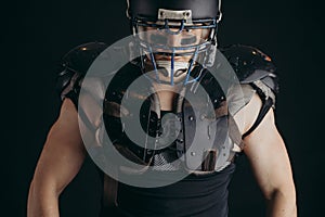 American football player with ball wearing helmet and protective shields