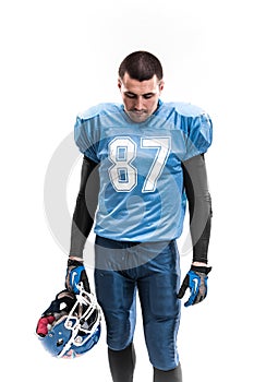 American Football Player with blue uniform on the scrimmage line. White background