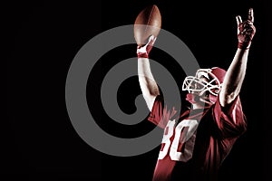 American football player cheering with arms up