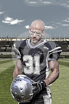 American football player in desolate stadium