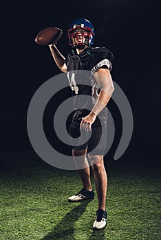 american football player on green grass throwing ball