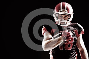 American football player in helmet holding rugby ball