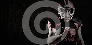 Composite image of american football player in helmet holding rugby ball