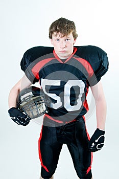 American football player holding helmet