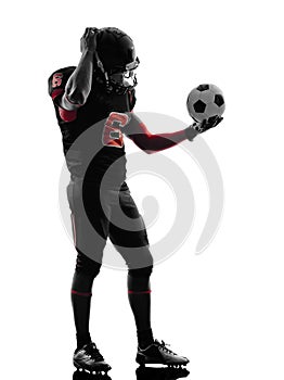 American football player holding soccer ball confused silhouett