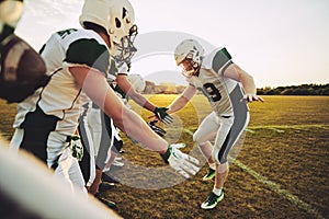 American football player low fiving his teammates after a game