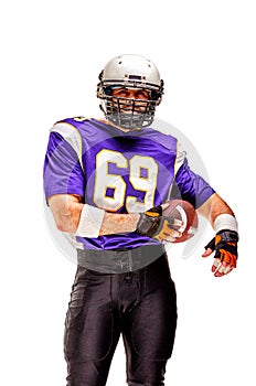American football player posing with ball on black background. Super Bowl concept. Concept American football, portrait