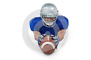 American football player reaching towards ball