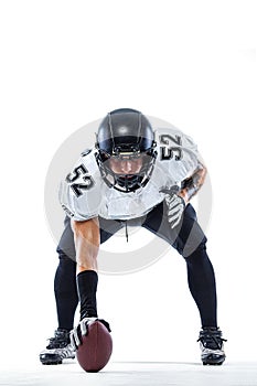 American football player. Sportsman with ball in helmet on stadium in action. Sport wallpaper. Team sports.