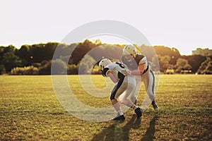 American football player tackling a teammate during practice