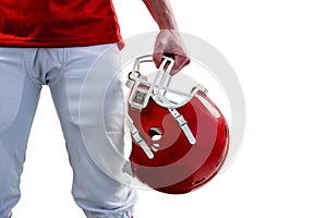 An american football player taking his helmet on hand