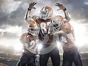 American football players in action on stadium photo