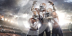 American football players in action on stadium photo