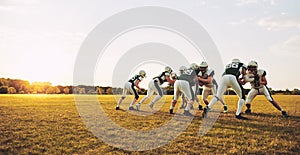 American football players doing practicing defense on a sports f