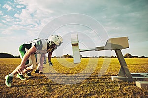 American football players doing tackling drills on a sports field