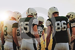 American football players standing in a huddle before a game