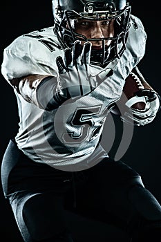 American football sportsman player in helmet isolated run in action on black background. Sport and motivation wallpaper