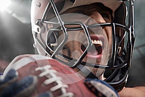 American football sportsman player on stadium with lights on background