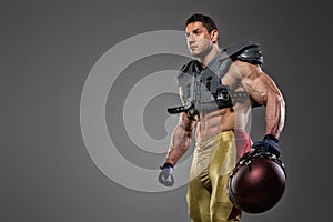 American football sportsman player on stadium with lights on background