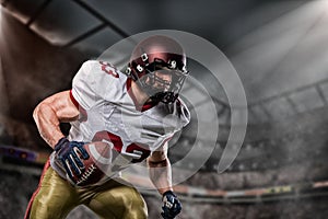 American football sportsman player on stadium with lights on background