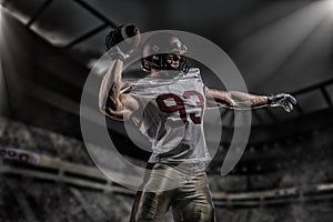 American football sportsman player on stadium with lights on background