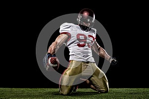 American football sportsman player on stadium with lights on background