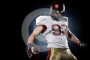 American football sportsman player on stadium with lights on background