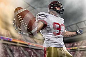 American football sportsman player on stadium with lights on background