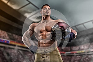 American football sportsman player on stadium with lights on background